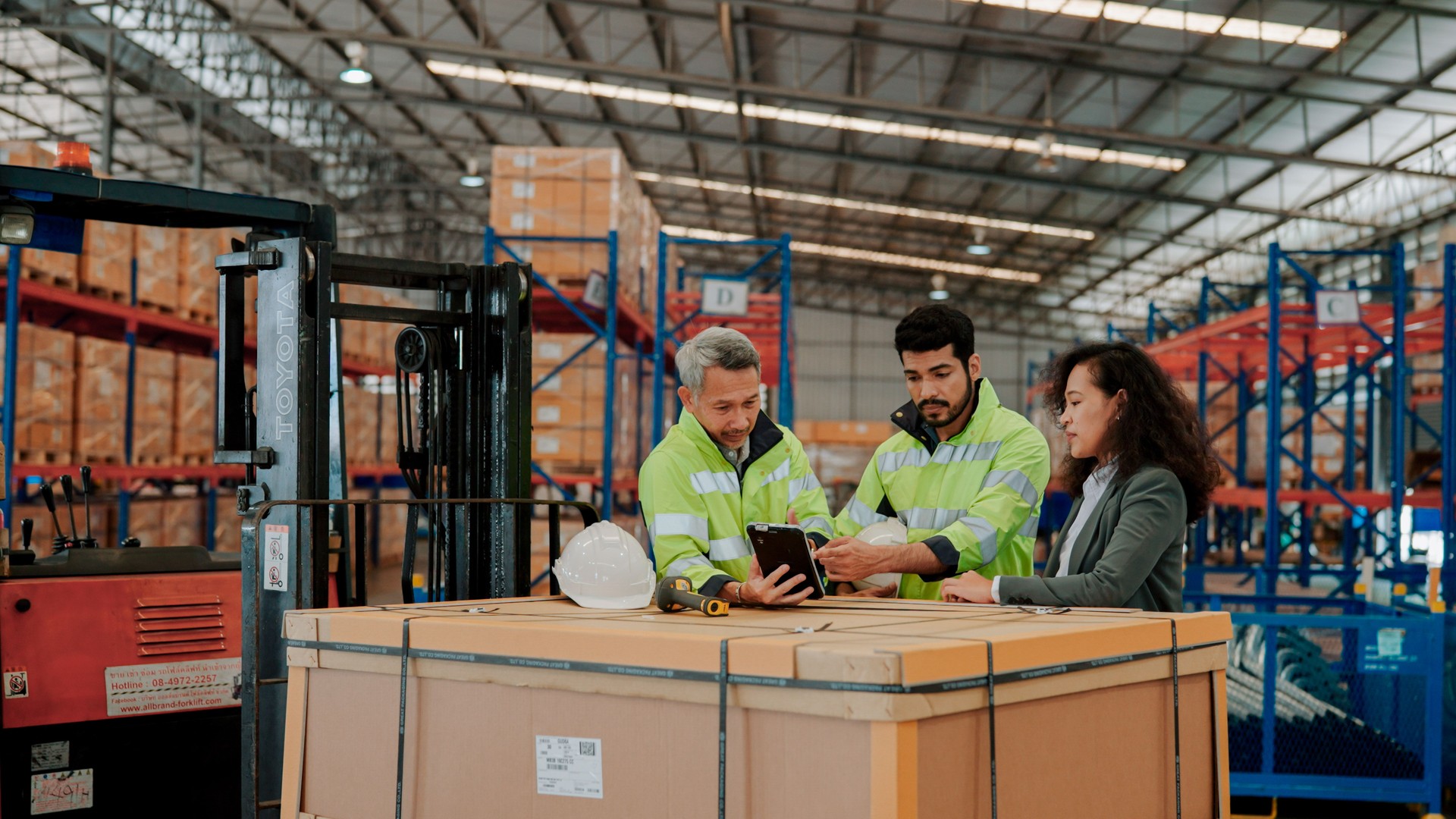 Female Auditor Asking Questions to Warehouse Workers During On-site Inspection.